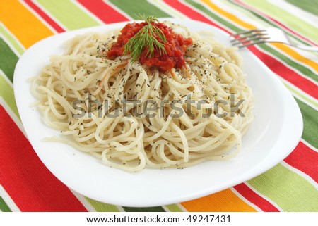 Spaghetti with the tomato sauce on the white plate
