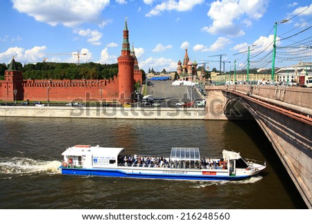 MOSCOW, RUSSIA - AUGUST 20, 2014: Pleasure boat goes to the Big Moskvoretsky bridge over the Moscow river on the background of the Kremlin.