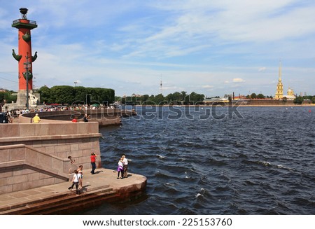 RUSSIAN, SAINT - PETERSBURG - JULY 15, 2014: Tourists look at the Peter and Paul Fortress with the Spit of Vasilievsky Island.