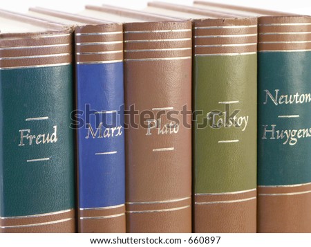 Leather bound books by great historic authors stand together with isolated white background.