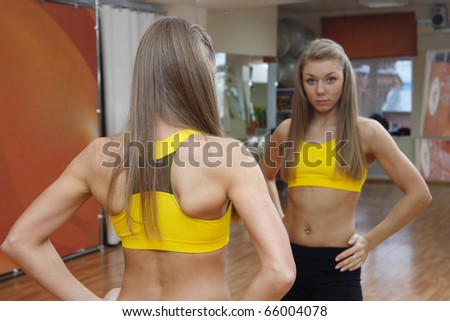Girl looking in mirror gym indoors