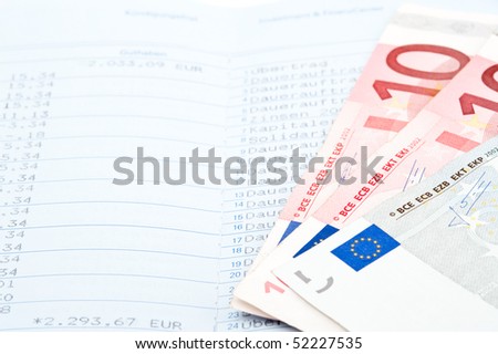 Close-up of savings in money and bank statement