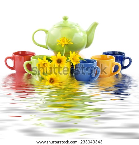 Set of multi-colored utensils for tea and coffee. Tea, coffee pot, six cups and yellow water. Tea ceremony. Isolated on white background. Reflection