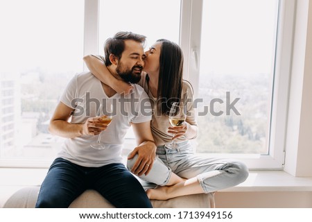 Similar – Image, Stock Photo Woman with glass kissing partner for joint selfie in park