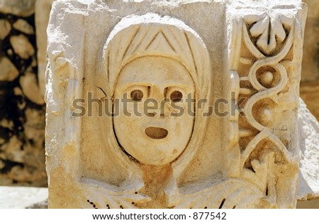 woman face bas-relief in the ancient greek theatre