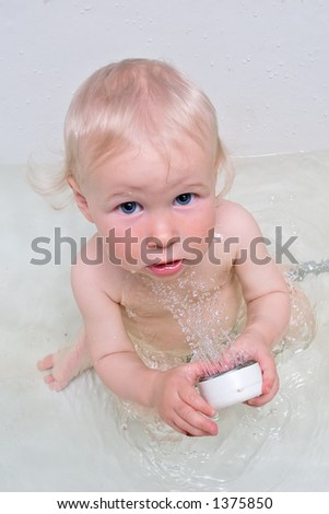 funny baby in bath with shower