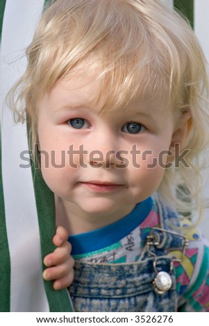 portrait of two years old smiling blonde girl