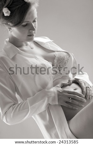 fine-art portrait of a pregnant woman on gray background