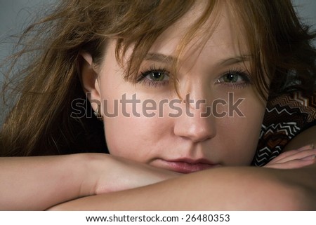 beautiful grey-eyed woman close-up portrait on gray background