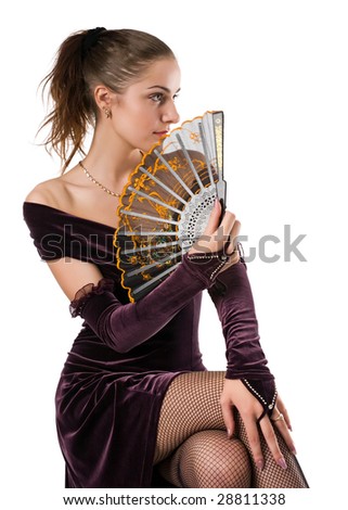 beautiful girl in purple clothes sits with a fan in hands and looks aside, isolated on white