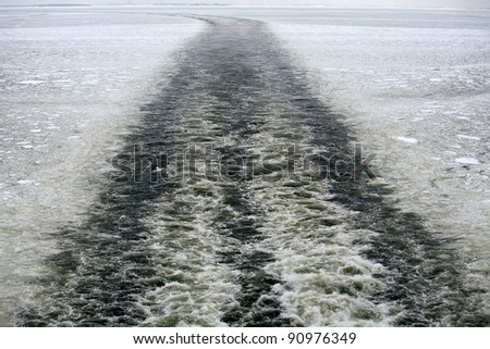 track of vessel on broken ice across sea water