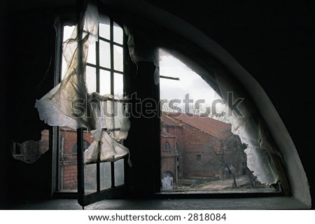 A view through a window in a destroyed house.
