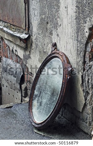 Thrown Out Old Mirror Standing Against Wall