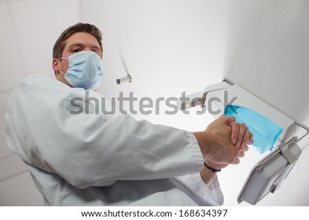 doctor disinfecting hands
