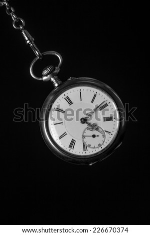 old pocket watch in black and white
