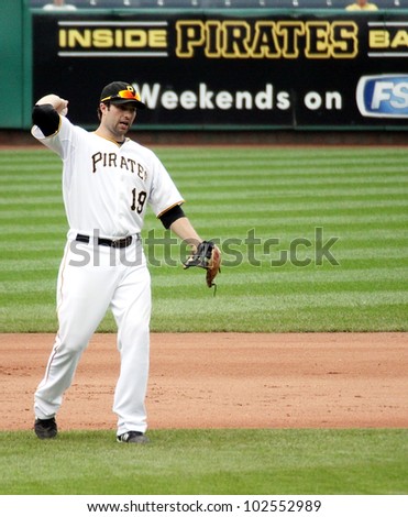 PITTSBURGH - SEPTEMBER 24 : Neil Walker of the Pittsburgh Pirates throws the ball to first against the Cincinnati Reds on September 24, 2009 in Pittsburgh, PA.