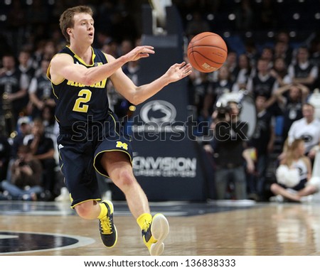 UNIVERSITY PARK, PA - FEBRUARY 27: Michigan\'s Spike Albrecht No. 2 passes asPenn State defends at the Byrce Jordan Center February 27, 2013 in University Park, PA