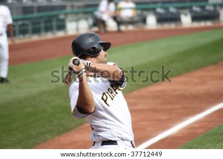 PITTSBURGH - SEPTEMBER 24 : Garrett Jones of Pittsburgh Pirates swings  at a  pitch against Cincinnati Reds on September 24, 2009 in Pittsburgh, PA.