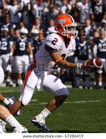 UNIVERSITY PARK, PA - OCT 9: Illinois quarterback No. 2, Nathan Scheelhaase gets the snap and hands off  against Penn State at Beaver Stadium October 9, 2010 in University Park, Pa