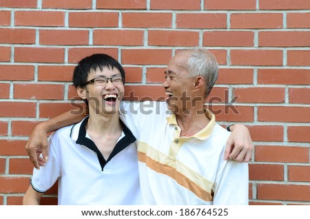 Asian father and son laugh happily