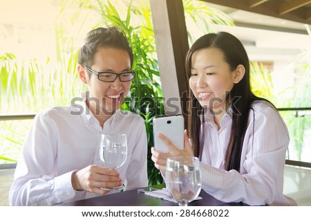 Young asian female executive doing business presentation with handphone