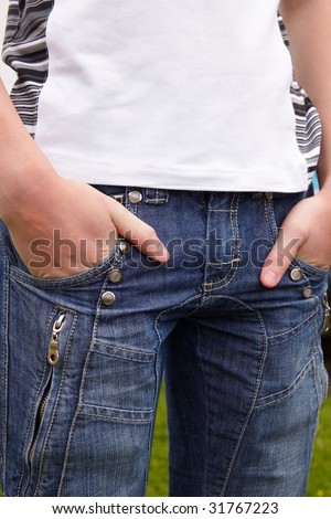 Closeup of cool blue jeans and man hands in pocket