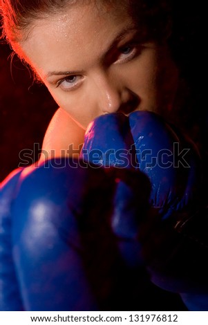 portrait of a aggressive woman boxer