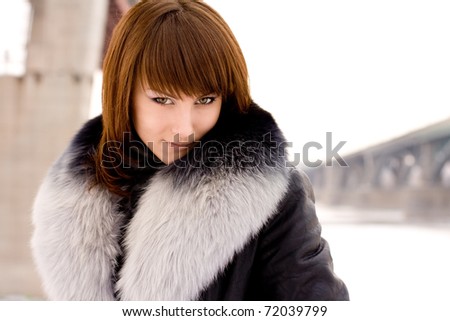 young beautiful girl in a fur collar