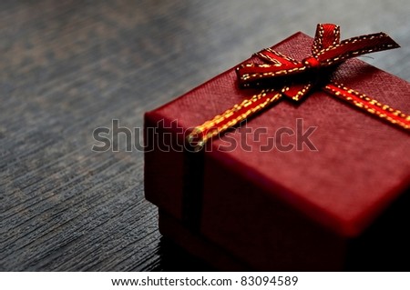 Gift box on table. The luxury gift certificate template or graphic art background. May be used for a birthday, valentine or xmas present card design.