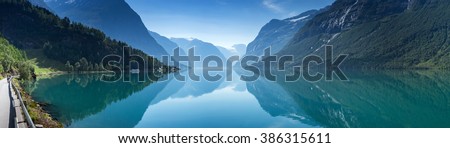 Similar – Image, Stock Photo A fjord in Norway. In the foreground the sea and in the background snow-covered mountain tops. The blue sky is decorated by veil clouds.