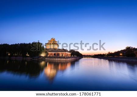 the turret and moat of beijing forbidden city at dusk ,China