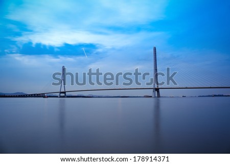 nanjing third yangtze river bridge in nightfall, is the world\'s first arc-shaped steel tower cable-stayed bridge,China
