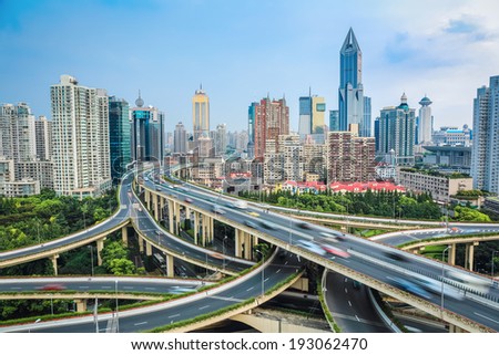 vehicle motion blur on the elevated road  junction  with modern city skyline