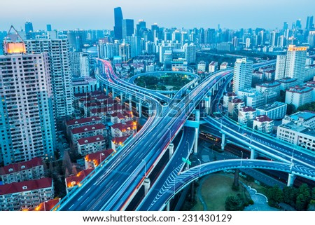 junction of city road at dusk in prosperous city of shanghai , China