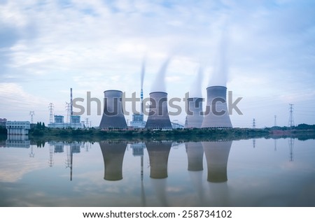 power plant in riverside , a row of cooling tower with the reflection