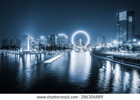 tianjin haihe river at night with ferris wheel , China