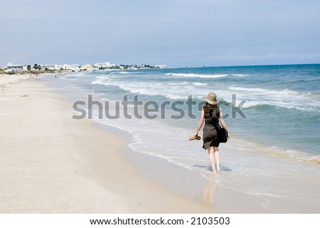 Woman walking at the sea beach