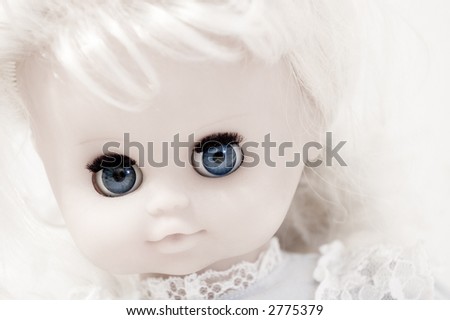 Closeup of vintage doll\'s face with blue eyes