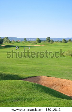 Golf course with distant group of golfers in background