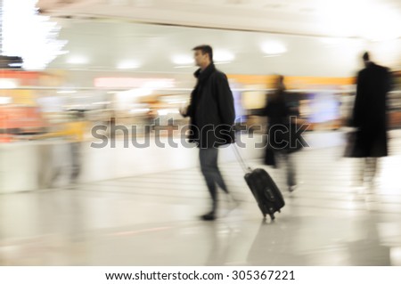 Fast walking businessmen in an airport. Business or travel background.