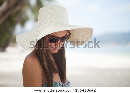 Beautiful woman posing on a paradise beach