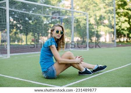beautiful girl posing on the football field