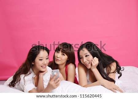 Young women on bed and isolated on pure background