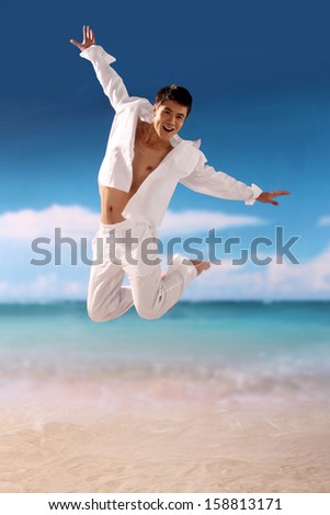 Man jumping for joy at the beach