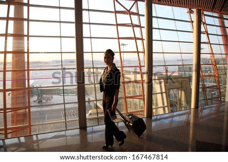 A shot of Businesswoman pulling a suitcase in airport