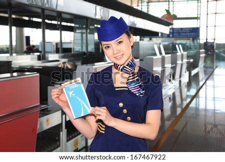 A shot of Chinese flight attendant holding a ticket