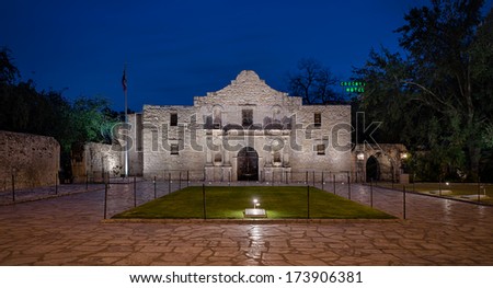 SAN ANTONIO, TEXAS - JANUARY 7: The Alamo, originally known as Mission San Antonio de Valero, with the Crockett Hotel neon sign in the background on January 7, 2014 in San Antonio, Texas