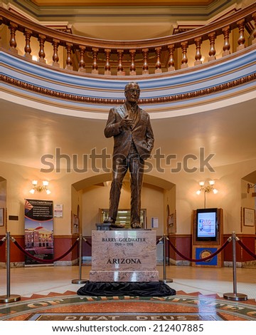 PHOENIX, ARIZONA - AUGUST 6: Barry Goldwater statue behind state seal in the Arizona State Capitol building on August 6, 2014 in Phoenix, Arizona