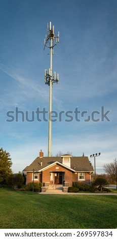 ORLAND PARK, ILLINOIS - APRIL 13: A cellular tower drawfs the Orland Park Area Chamber of Commerce building on April 13, 2015 in Orland Park, Illinois