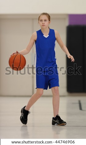 Young girl dribbling basketball